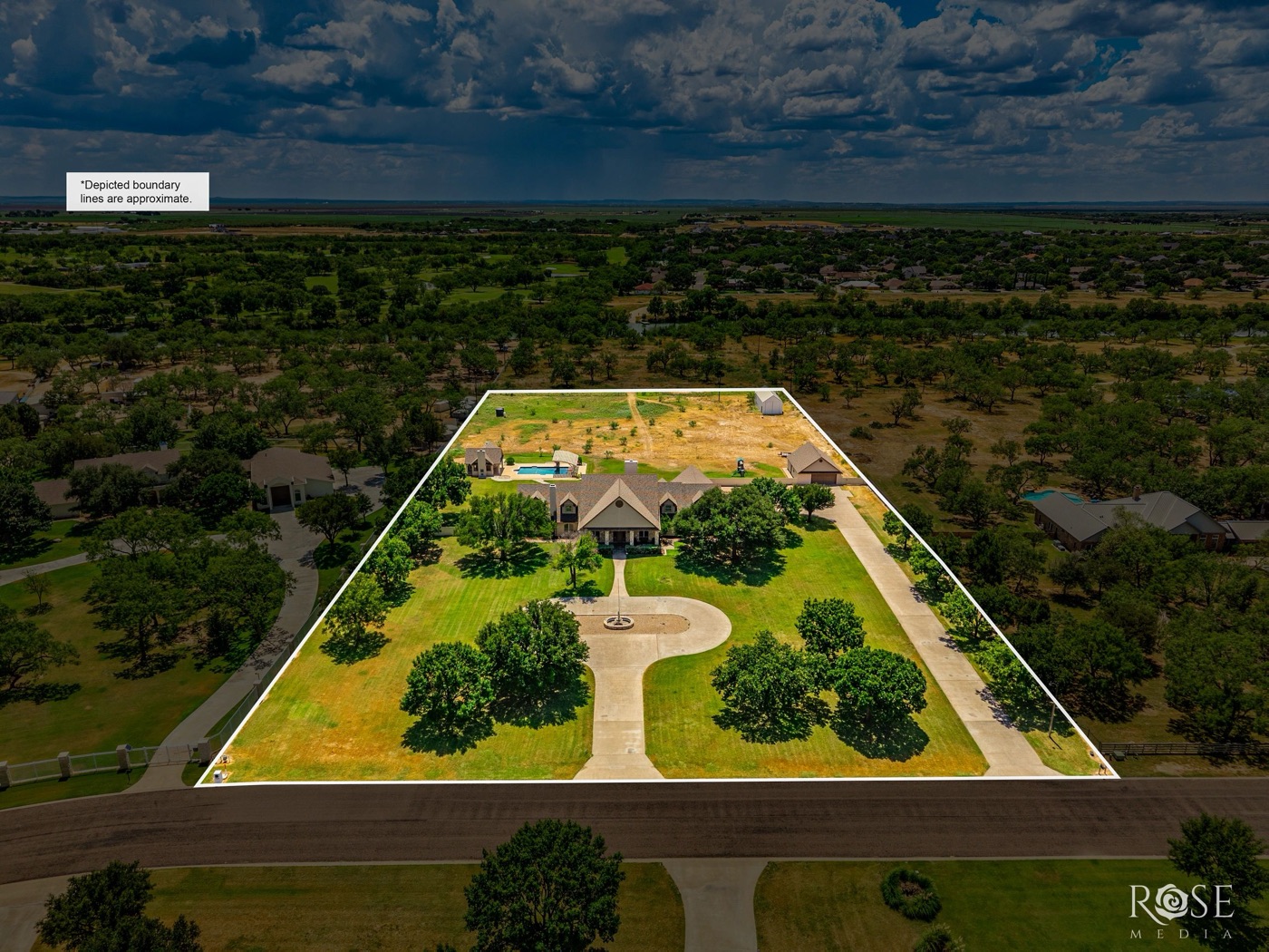 Aerial view of an acreage property under a dramatic sky