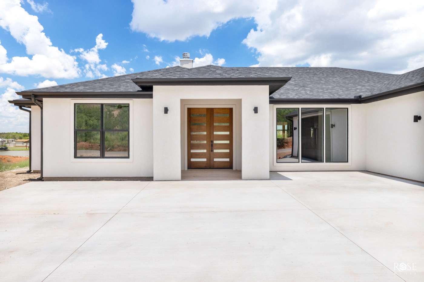 White stucco home entry with wood double doors