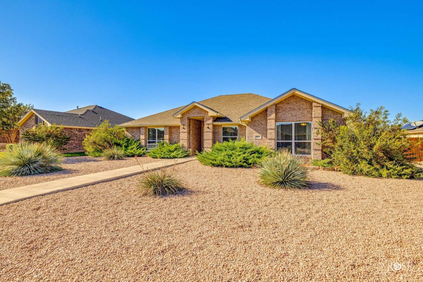 Brick home with drought-tolerant xeriscape landscaping